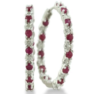 Hoop earrings will always be in style!  Be sure to grab these fabulous ruby and diamond hoop earrings.  Each earring has 12 ruby stones and are set in sterling silver.  Dangling at about 1 inches down, they are perfect for everyone.  Total gem weight is 1.5 carats.  Diamond content is .01 carats, diamond color is J-K and diamond clarity is I2-I3.