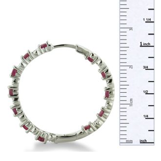 Hoop earrings will always be in style!  Be sure to grab these fabulous ruby and diamond hoop earrings.  Each earring has 12 ruby stones and are set in sterling silver.  Dangling at about 1 inches down, they are perfect for everyone.  Total gem weight is 1.5 carats.  Diamond content is .01 carats, diamond color is J-K and diamond clarity is I2-I3.