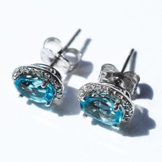 2 1/4 Carat Oval Shape Blue Topaz and Halo Diamond Stud Earrings In 14 Karat White Gold