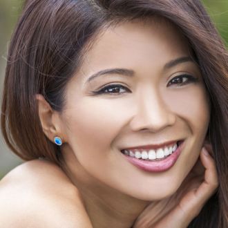 2 1/4 Carat Oval Shape Blue Topaz and Halo Diamond Stud Earrings In 14 Karat White Gold