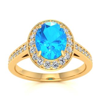 1 3/4 Carat Oval Shape Blue Topaz and Halo Diamond Ring In 14 Karat Yellow Gold
