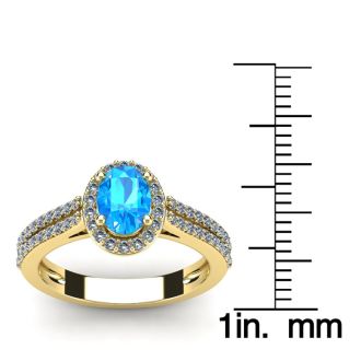 1 1/2 Carat Oval Shape Blue Topaz and Halo Diamond Ring In 14 Karat Yellow Gold