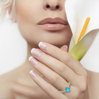 1 1/2 Carat Oval Shape Blue Topaz and Halo Diamond Ring In 14 Karat Yellow Gold