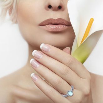 Aquamarine Ring: Aquamarine Jewelry: 1 1/4 Carat Oval Shape Aquamarine and Halo Diamond Ring In 14 Karat White Gold