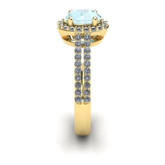 Aquamarine Ring: Aquamarine Jewelry: 1 1/4 Carat Oval Shape Aquamarine and Halo Diamond Ring In 14 Karat Yellow Gold