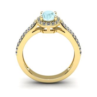 Aquamarine Ring: Aquamarine Jewelry: 1 1/4 Carat Oval Shape Aquamarine and Halo Diamond Ring In 14 Karat Yellow Gold