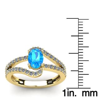 1 1/2 Carat Oval Shape Blue Topaz and Fancy Diamond Ring In 14 Karat Yellow Gold