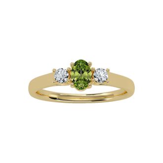 3/4 Carat Oval Shape Peridot and Two Diamond Ring In 14 Karat Yellow Gold