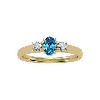 3/4 Carat Oval Shape Blue Topaz and Two Diamond Ring In 14 Karat Yellow Gold