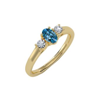 3/4 Carat Oval Shape Blue Topaz and Two Diamond Ring In 14 Karat Yellow Gold