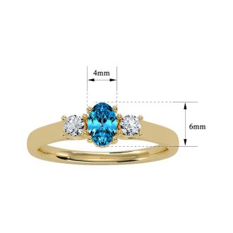 3/4 Carat Oval Shape Blue Topaz and Two Diamond Ring In 14 Karat Yellow Gold