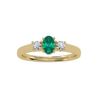 1/2 Carat Oval Shape Emerald and Two Diamond Ring In 14 Karat Yellow Gold