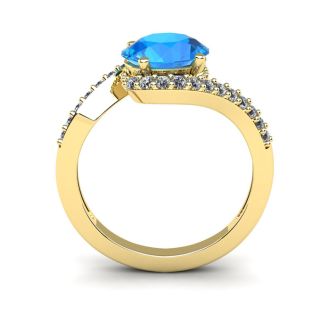 1 3/4 Carat Oval Shape Blue Topaz and Halo Diamond Ring In 14 Karat Yellow Gold