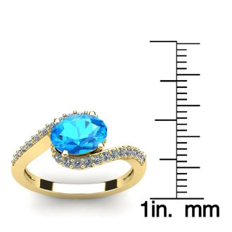 1 3/4 Carat Oval Shape Blue Topaz and Halo Diamond Ring In 14 Karat Yellow Gold