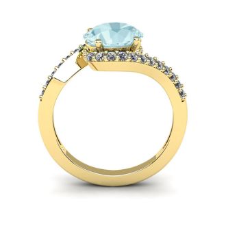 Aquamarine Ring: Aquamarine Jewelry: 1 1/2 Carat Oval Shape Aquamarine and Halo Diamond Ring In 14 Karat Yellow Gold