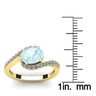 Aquamarine Ring: Aquamarine Jewelry: 1 1/2 Carat Oval Shape Aquamarine and Halo Diamond Ring In 14 Karat Yellow Gold