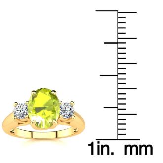 1 1/2 Carat Oval Shape Peridot and Two Diamond Ring In 14 Karat Yellow Gold