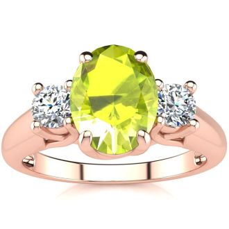 1 1/2 Carat Oval Shape Peridot and Two Diamond Ring In 14 Karat Rose Gold