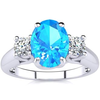 1 3/4 Carat Oval Shape Blue Topaz and Two Diamond Ring In 14 Karat White Gold