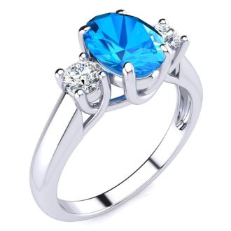 1 3/4 Carat Oval Shape Blue Topaz and Two Diamond Ring In 14 Karat White Gold