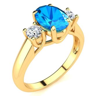 1 3/4 Carat Oval Shape Blue Topaz and Two Diamond Ring In 14 Karat Yellow Gold