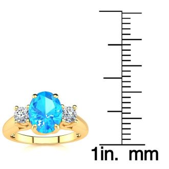 1 3/4 Carat Oval Shape Blue Topaz and Two Diamond Ring In 14 Karat Yellow Gold