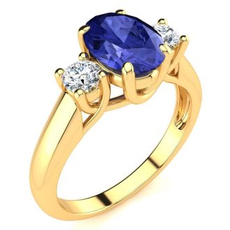 1 1/2 Carat Oval Shape Tanzanite and Two Diamond Ring In 14 Karat Yellow Gold