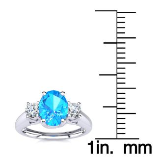 1 1/5 Carat Oval Shape Blue Topaz and Two Diamond Ring In 14 Karat White Gold
