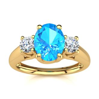 1 1/5 Carat Oval Shape Blue Topaz and Two Diamond Ring In 14 Karat Yellow Gold
