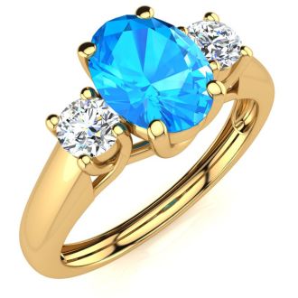 1 1/5 Carat Oval Shape Blue Topaz and Two Diamond Ring In 14 Karat Yellow Gold
