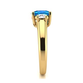 1 1/5 Carat Oval Shape Blue Topaz and Two Diamond Ring In 14 Karat Yellow Gold
