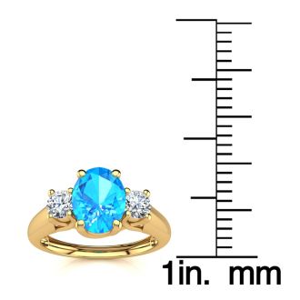 1 1/5 Carat Oval Shape Blue Topaz and Two Diamond Ring In 14 Karat Yellow Gold
