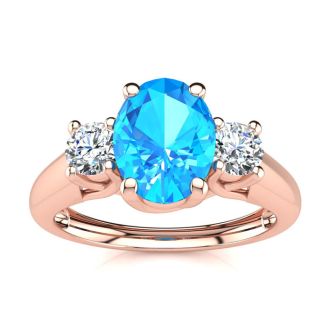 1 1/5 Carat Oval Shape Blue Topaz and Two Diamond Ring In 14 Karat Rose Gold
