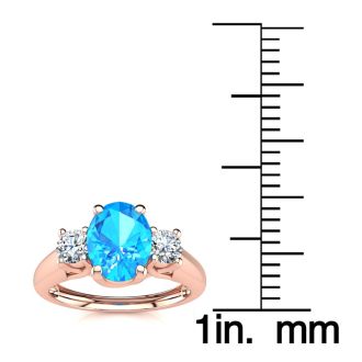 1 1/5 Carat Oval Shape Blue Topaz and Two Diamond Ring In 14 Karat Rose Gold
