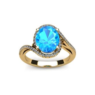 1 3/4 Carat Oval Shape Blue Topaz and Halo Diamond Ring In 14 Karat Yellow Gold