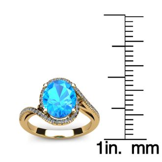 1 3/4 Carat Oval Shape Blue Topaz and Halo Diamond Ring In 14 Karat Yellow Gold