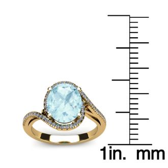 Aquamarine Ring: Aquamarine Jewelry: 1 1/3 Carat Oval Shape Aquamarine and Halo Diamond Ring In 14 Karat Yellow Gold