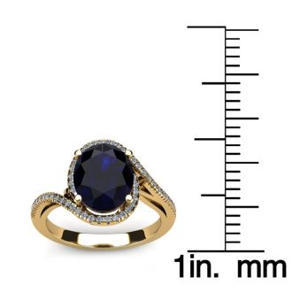 1 3/4 Carat Oval Shape Sapphire and Halo Diamond Ring In 14 Karat Yellow Gold
