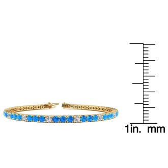 3 3/4 Carat Blue Topaz And Diamond Alternating Tennis Bracelet In 14 Karat Yellow Gold, 7 Inches