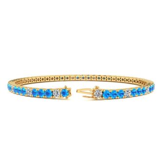 4 Carat Blue Topaz And Diamond Alternating Tennis Bracelet In 14 Karat Yellow Gold, 7 1/2 Inches