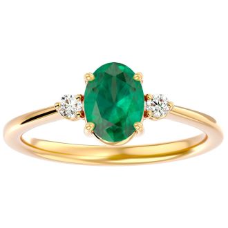 1 1/4 Carat Oval Shape Emerald and Two Diamond Ring In 14 Karat Yellow Gold
