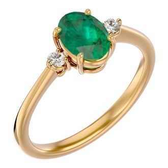 1 1/4 Carat Oval Shape Emerald and Two Diamond Ring In 14 Karat Yellow Gold