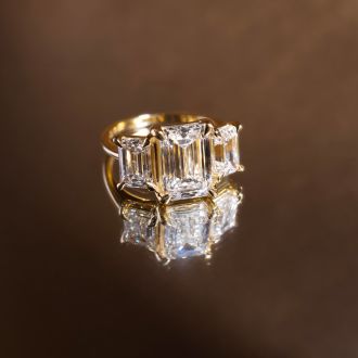 5 Carat Emerald Cut Lab Grown Diamond Three Stone Engagement Ring In 14K Yellow Gold