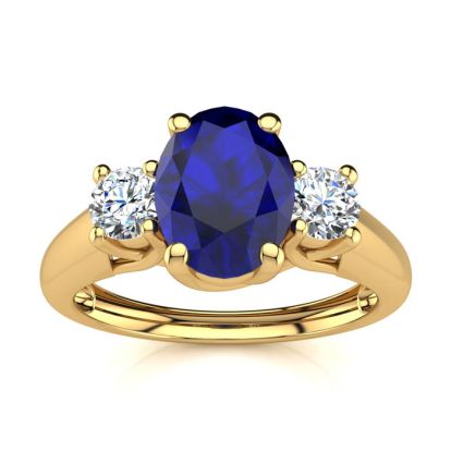 1 1/5 Carat Oval Shape Sapphire and Two Diamond Ring In 14 Karat Yellow Gold