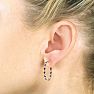 Hoop earrings will always be in style!  Be sure to grab these fabulous ruby and diamond hoop earrings.  Each earring has 12 ruby stones and are set in sterling silver.  Dangling at about 1 inches down, they are perfect for everyone.  Total gem weight is 1.5 carats.  Diamond content is .01 carats, diamond color is J-K and diamond clarity is I2-I3. Image-5