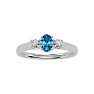 3/4 Carat Oval Shape Blue Topaz and Two Diamond Ring In 14 Karat White Gold Image-1