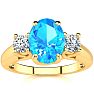 1 3/4 Carat Oval Shape Blue Topaz and Two Diamond Ring In 14 Karat Yellow Gold Image-1