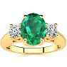 1 1/3 Carat Oval Shape Emerald and Two Diamond Ring In 14 Karat Yellow Gold Image-1