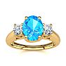 1 1/5 Carat Oval Shape Blue Topaz and Two Diamond Ring In 14 Karat Yellow Gold
 Image-1