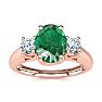 1 Carat Oval Shape Emerald and Two Diamond Ring In 14 Karat Rose Gold Image-1
